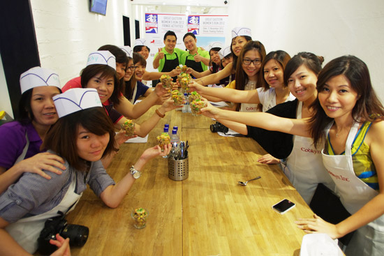 Kelvin (left), Dexter (right) and the group of ladies at the Cookyn Inc's kitchen