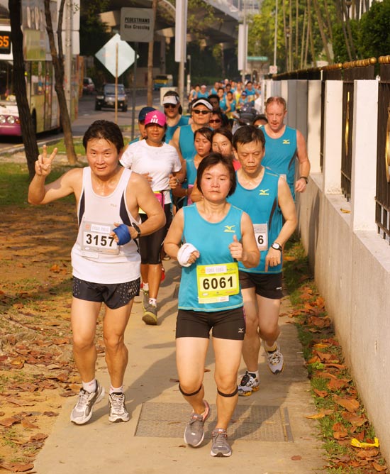 String of runners throng the walk path along Telok Blangah Road