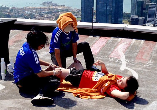A runner receiving massage therapy after the grueling climb