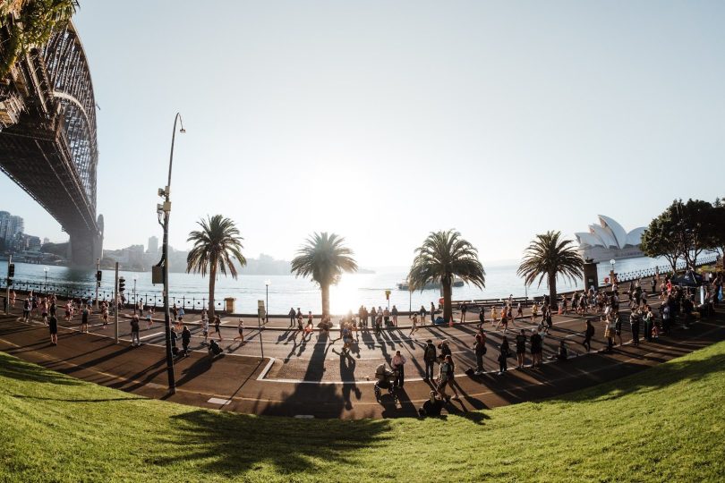 Runners along Sydney Harbour with the Harbour Bridge and Opera House in view during the TCS Sydney Marathon